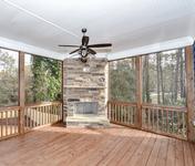 Screen deck with outdoor fireplace in Chamblee Craftsman Home built by Atlanta Homebuilder Waterford Homes
